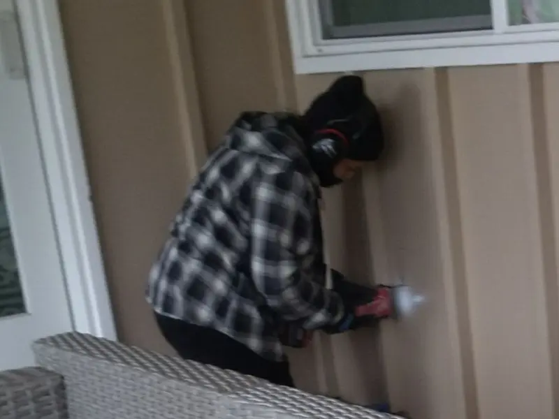 Professional electrician installing an exterior outlet in Riverside